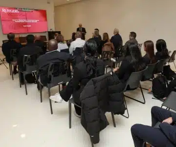 a group of people sitting in a classroom