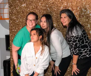 a group of women posing for the camera