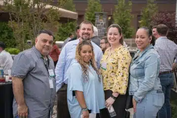 a group of people standing outside posing for the camera