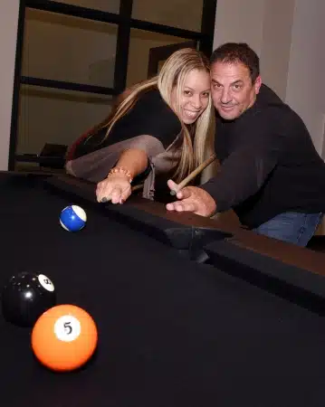 a man and woman shooting pool